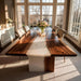 Modern dining room with a long wooden table and chairs near large windows.