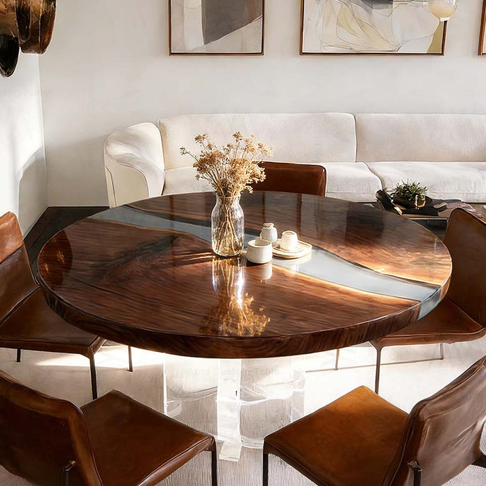 Round wooden dining table with four brown chairs in a modern living room.
