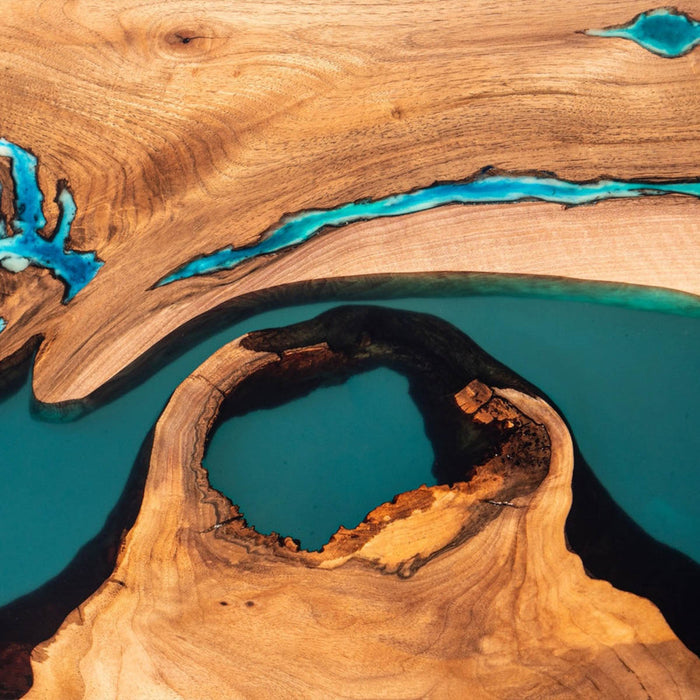 Blue epoxy live edge table crafted from natural walnut