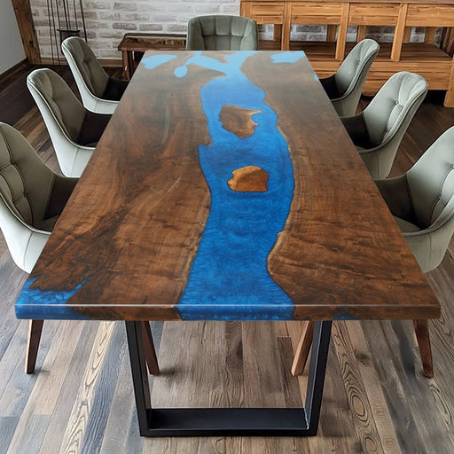A captivating epoxy resin wood river table with dark wood grain and vibrant blue epoxy resin inlays, creating a striking visual effect.
