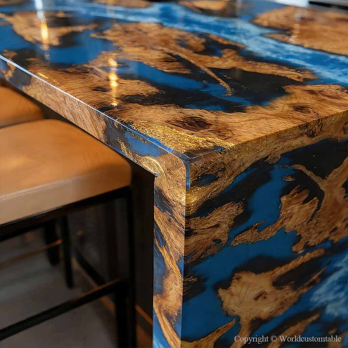 Close-up of blue epoxy river flowing through live edge burl wood