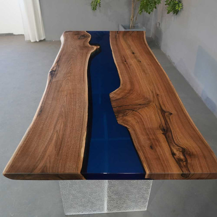 Solid walnut slab table with polished blue epoxy river and natural grain.