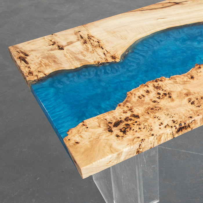 Blue epoxy resin river wood table that comfortably seats 6 to 8 people