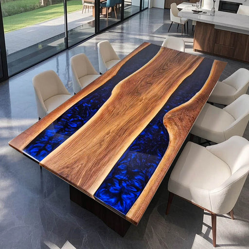 Custom walnut dining table with deep blue epoxy river and natural live edges