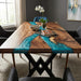 Walnut resin dining table featuring a blue green epoxy river