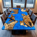 Live edge wood dining table with bright blue ocean epoxy resin river, styled in a modern lakeside dining room