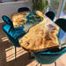 Blue resin river dining table featuring lotus leaves embedded in epoxy