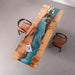 Modern dining table made of maple wood and blue epoxy resin with flowing river design