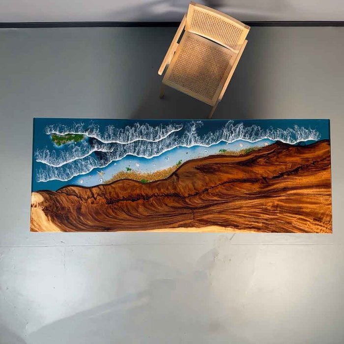 Tabletop with a scenic design of a beach and ocean on a wooden surface.