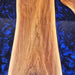 Bold walnut and navy epoxy table designed as a centerpiece for luxury homes