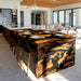 Burl wood black resin epoxy waterfall table in a luxury dining room