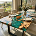 Burl wood dining table featuring a dramatic green resin design