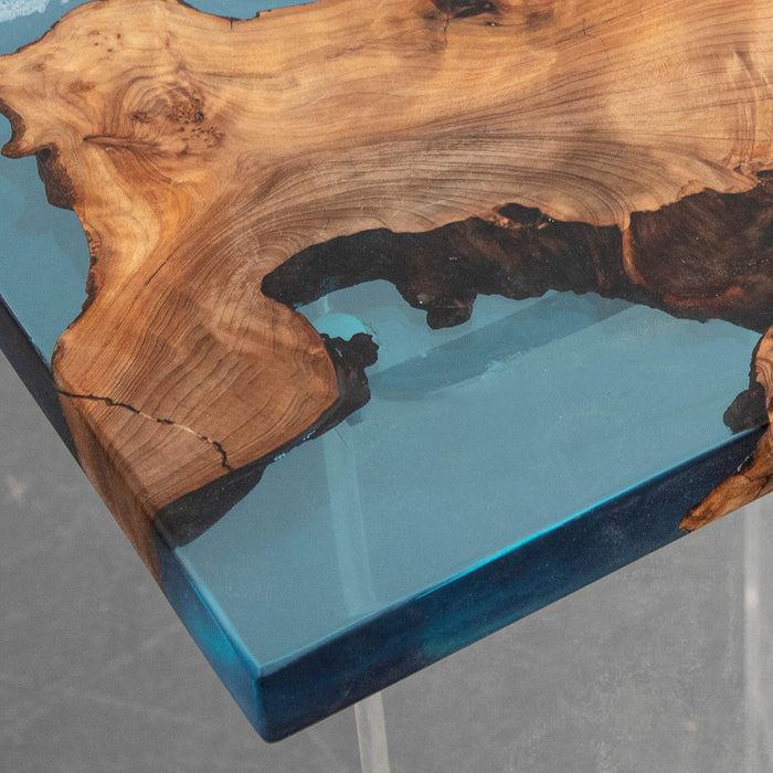 Wooden table with blue resin finish on a gray background