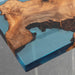 Wooden table with blue resin finish on a gray background