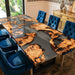 A large rectangular burl wood dining table with smoky grey epoxy resin in a luxury home setting.