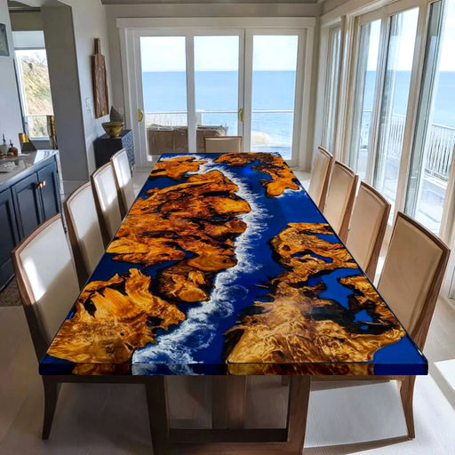 Dining table with a unique design in a room with large windows overlooking the ocean.
