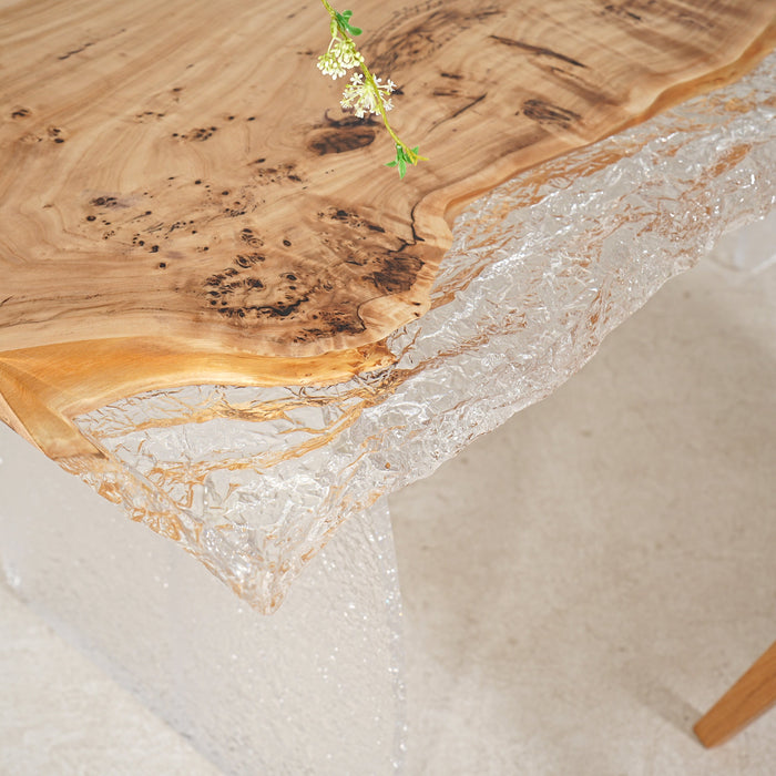 Sunlit clear epoxy river table with poplar slab, like water frozen in time.