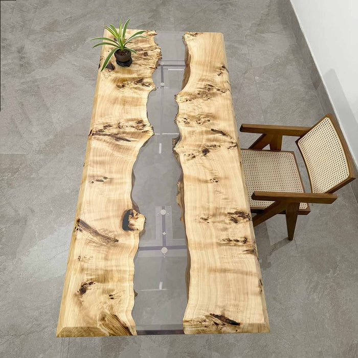 Wooden table with natural grain and a chair on a gray floor