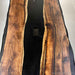 Close up view of walnut wood grain and epoxy river detail