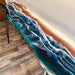 Table with blue resin design on a wooden floor