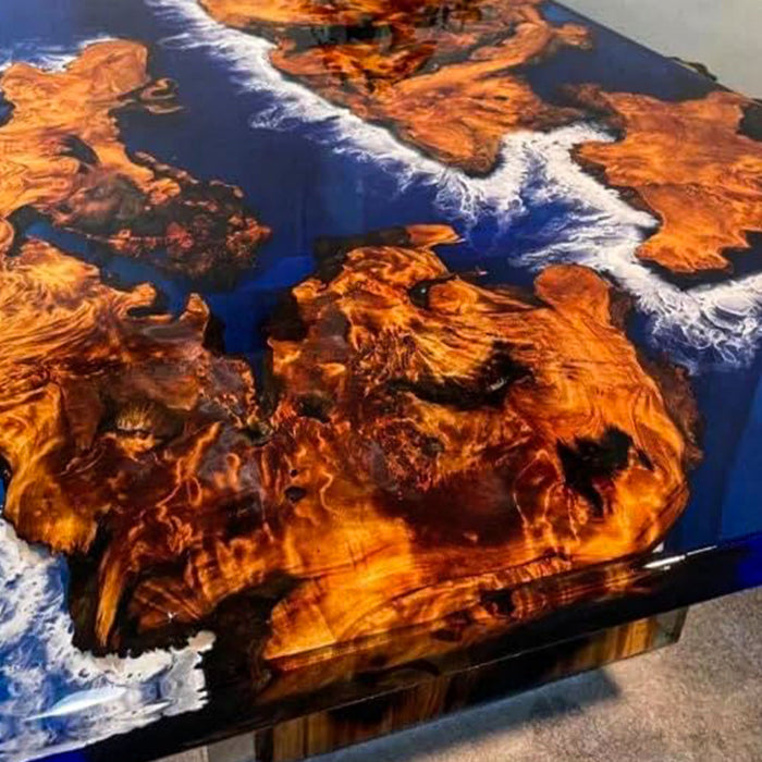 Wooden table with a unique design featuring blue and white patterns on a dark surface.