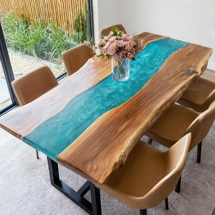 Coastal style walnut table with blue-green resin river placed in a modern interior.