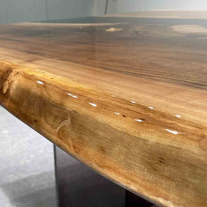 Close-up of a wooden table with a natural finish