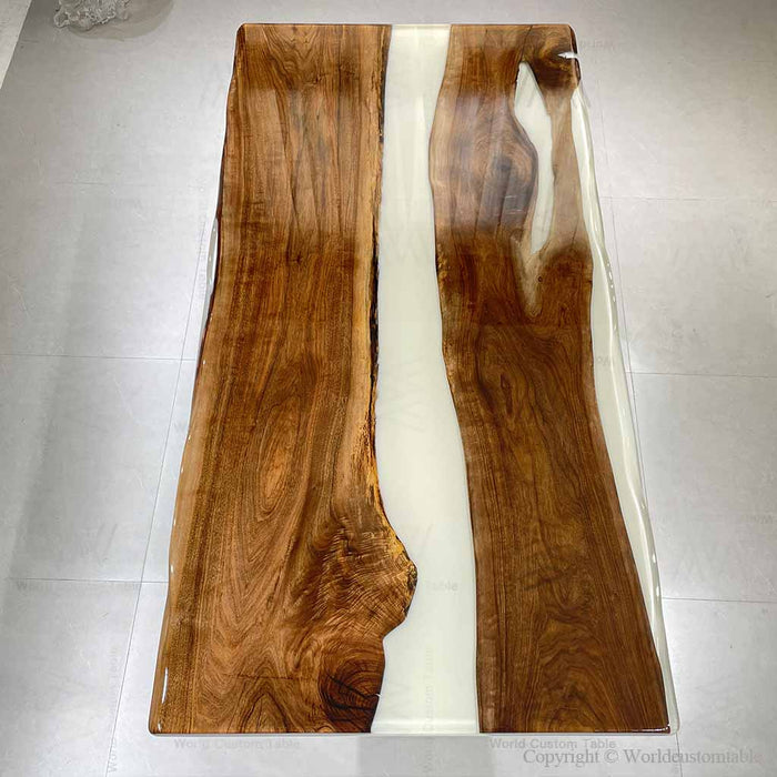 Contemporary epoxy dining table in an open kitchen and dining area with minimalist decor.