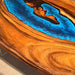 Contemporary live edge wood art furniture: a walnut coffee table with a glowing blue river.