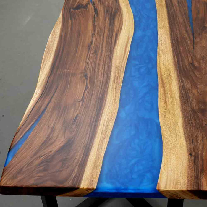 Wooden table with blue resin inlay on a gray surface