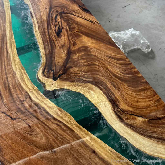Wooden table with green resin inlay on a concrete floor