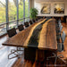 Black walnut epoxy conference table in a modern boardroom setting with executive chairs