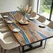 Custom handmade black walnut epoxy river dining table with unique grain patterns and smooth finish.