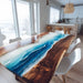 Dining table with blue resin design in a modern kitchen