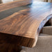 Custom black walnut resin dining table for contemporary interiors.