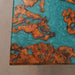 Close-up of a textured surface with copper and turquoise patterns