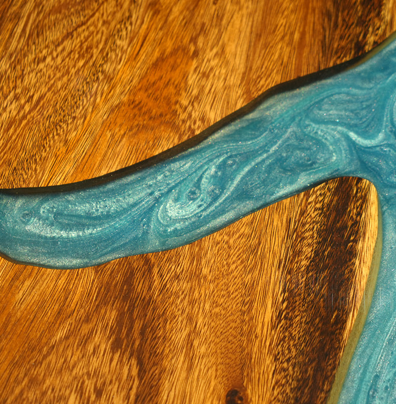 Live edge epoxy resin table with a vibrant blue river design and a durable clear resin tabletop finish.