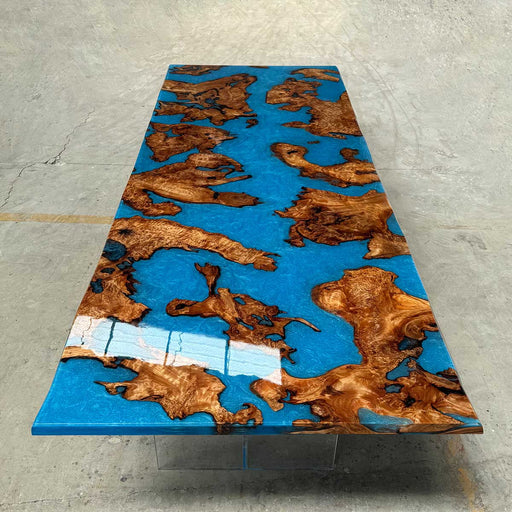 Table with blue resin and wooden surface on a concrete floor