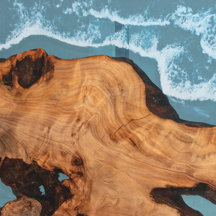 Wooden surface with natural grain pattern against a blue background with white waves