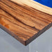 Close-up of a wooden surface with a blue background