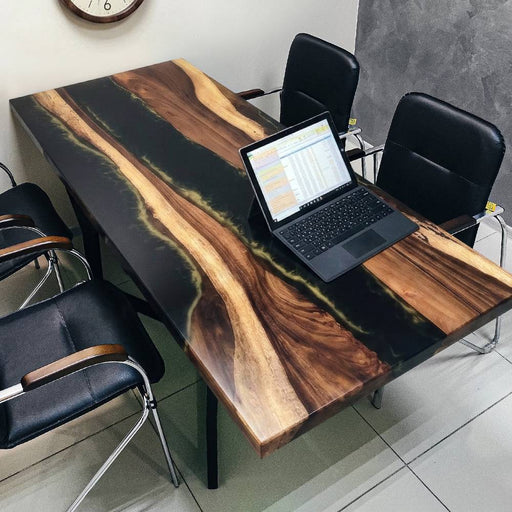 Large custom black epoxy resin river table used as an office conference desk.