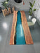 Handmade boardroom table with blue resin and natural wood edge for executive meetings.
