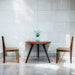 Dining table with two chairs against a tiled wall