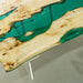 Wooden table with green resin inlay on a gray surface
