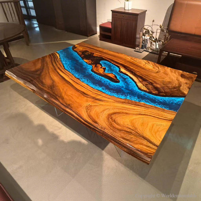 A custom handcrafted epoxy coffee table with rich walnut grain and a blue river design.
