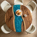 Handcrafted circular river table made from dark walnut and semi-transparent blue epoxy resin.