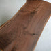 Custom irregular shaped black walnut table highlighting natural wood features and craftsmanship