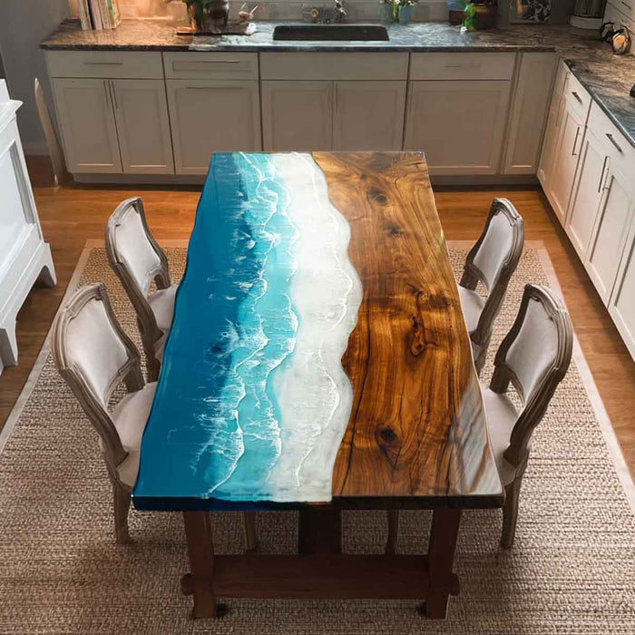 Dining table with a unique design featuring a wooden top and blue resin river, surrounded by chairs in a kitchen.