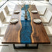 Custom live edge black walnut epoxy river dining table with blue resin center