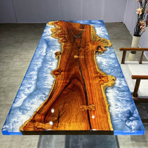 Handcrafted live edge wood table with ocean wave-inspired blue resin design, complemented by artistic stools with matching resin accents, perfect for contemporary dining and meeting spaces.